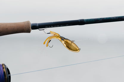 Nomad Design Squidtrex Patented Vibrating Fishing Lure- Scent Added TPE Soft Plastic Lure for Saltwater w/Strong BKK Assist Hooks, Fishing Bait that Catches Many Species, 75mm 1/2oz- Green Gold Gizzy
