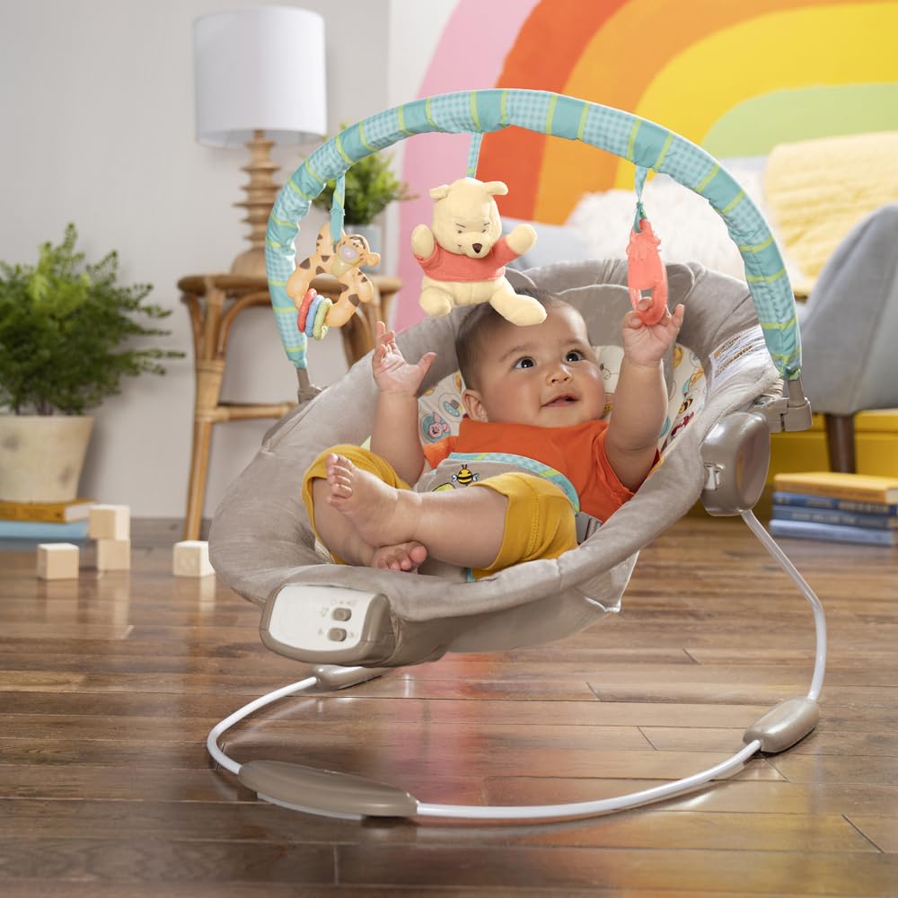 Bright Starts Disney Baby Winnie The Pooh Baby Bouncer Soothing Vibrations Deluxe Infant Seat - Faux Suede, Music, Removable -Toy Bar, 0-6 Months 6-20 lbs (Dots & Hunny Pots)